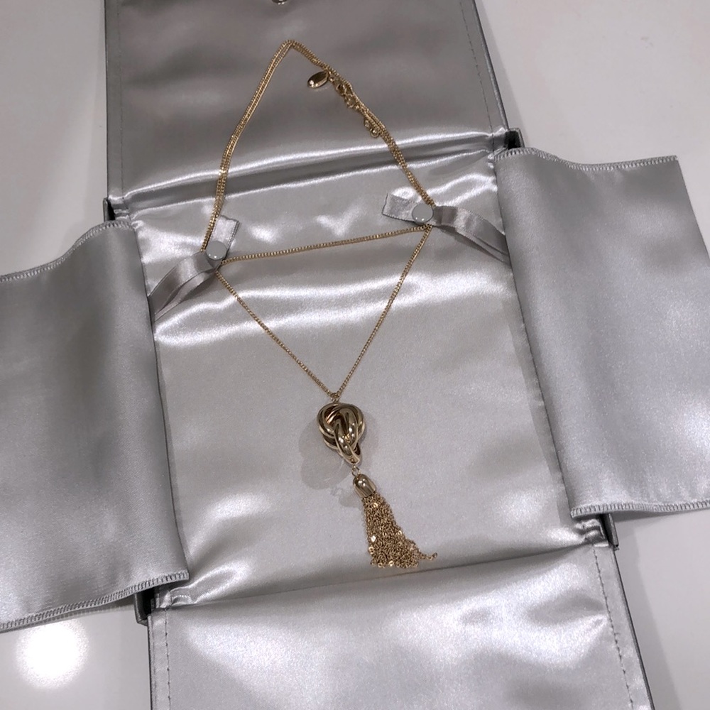 People’s long gold knot necklace